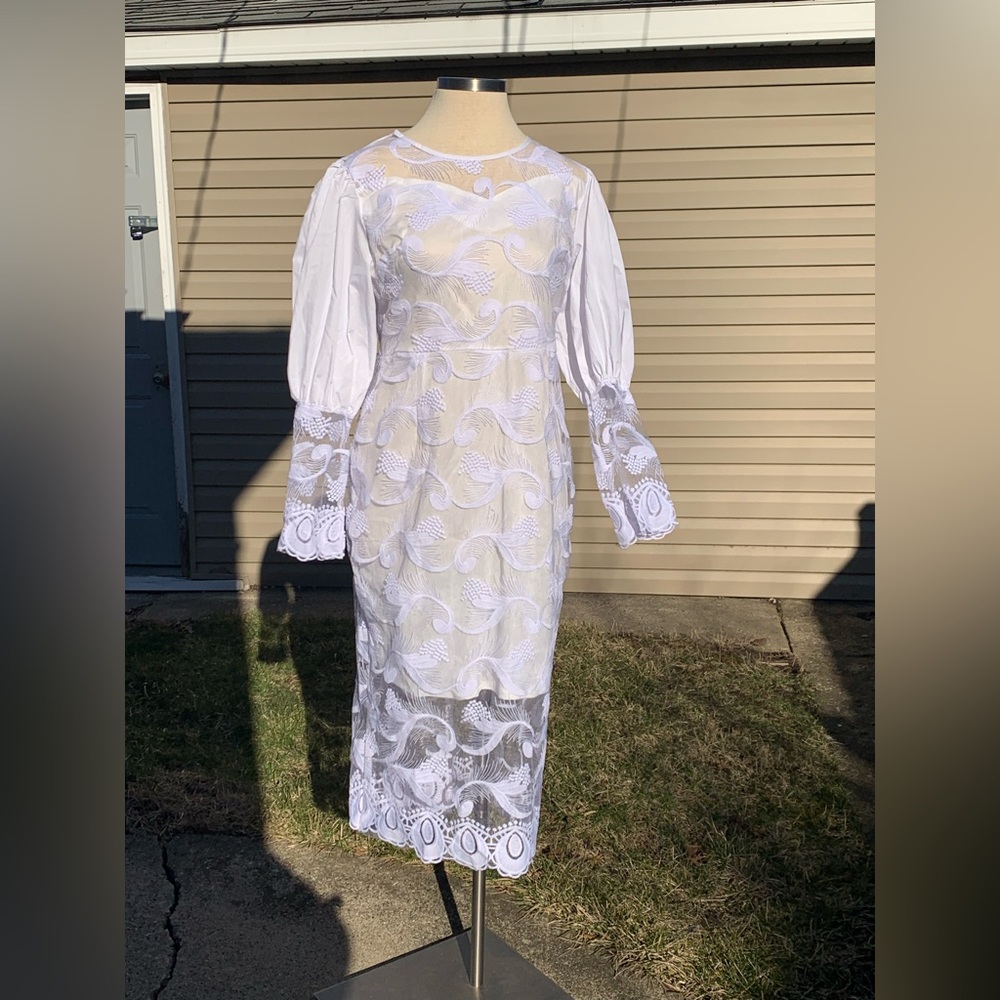 White long sleeve dress with a split.